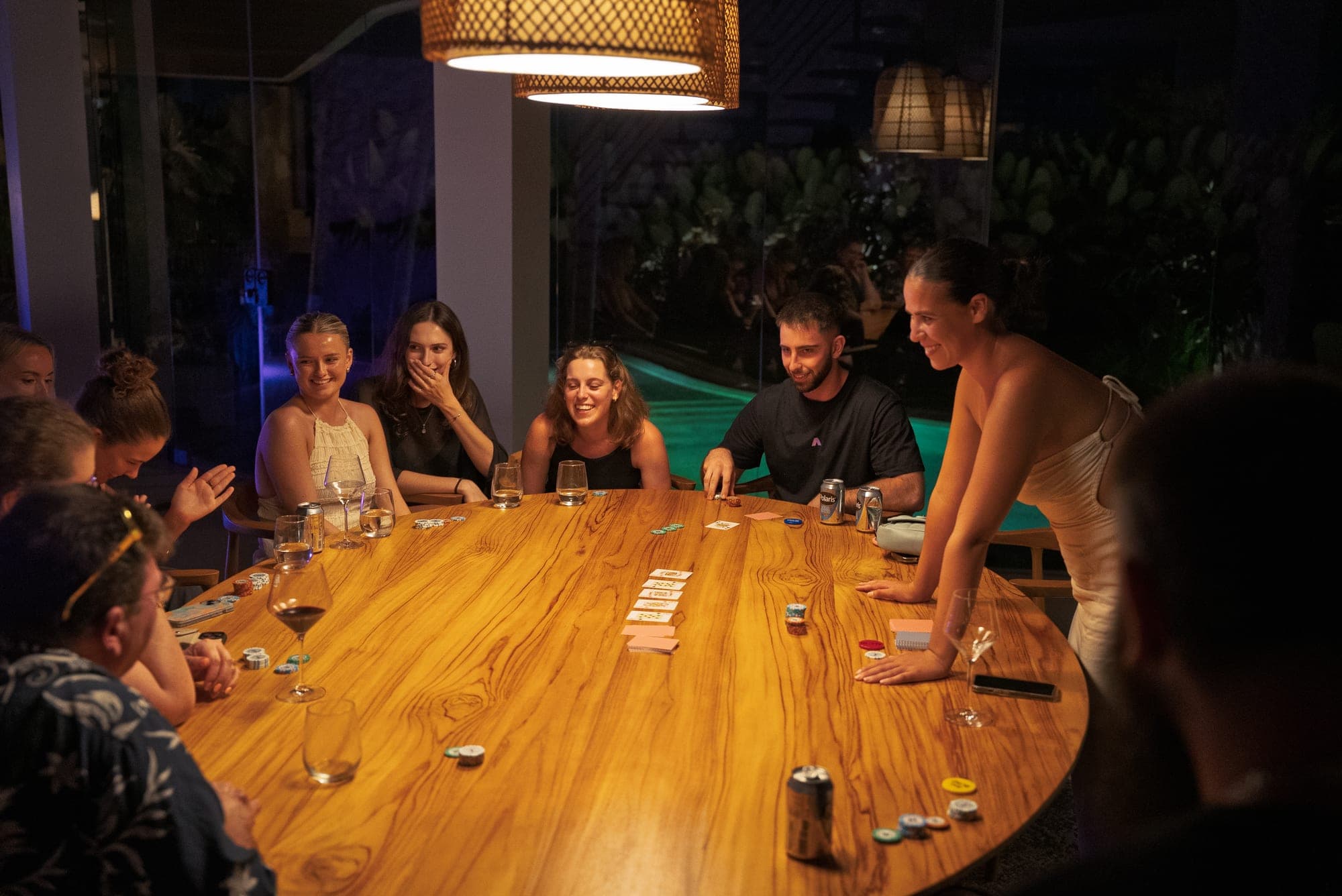 HeyAmara members laughing around a table at an evening event